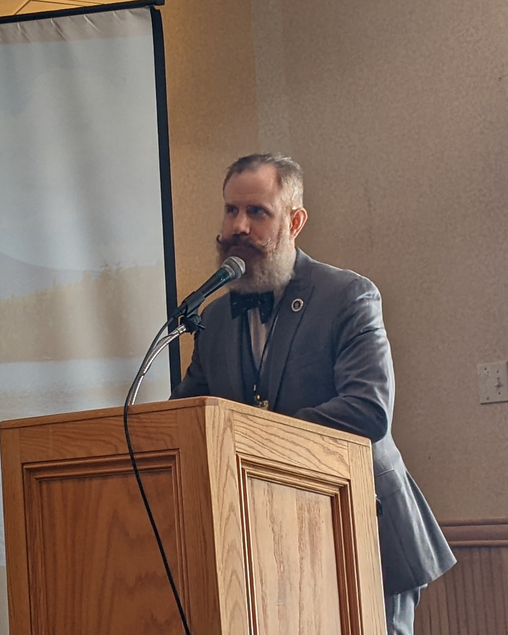 Mickey Mullin speaking at a podium